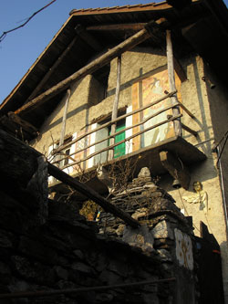 The stone house with its wooden balcony