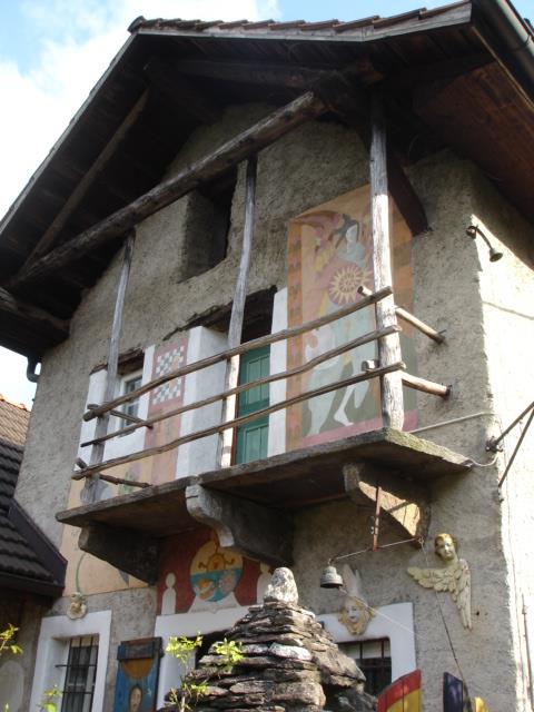The stone house with its wooden balcony